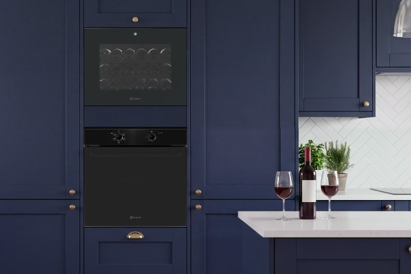 DeSantii 45cm wine cooler stacked above a DeSantii oven in navy kitchen units